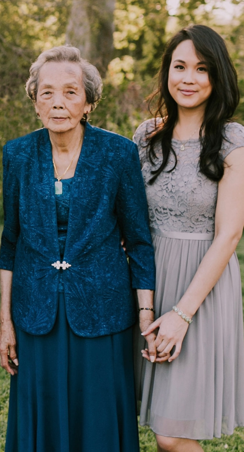 Dressed up grandmother and her granddaugther, caregiver, and Founder of Hydro Gummy holding hands and standing closely